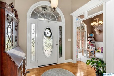 Featuring wood flooring and crown molding.