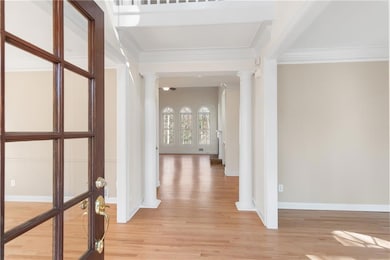 Bright, open entryway featuring beautiful light fi