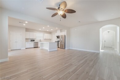 Unfurnished living room featuring arched walkways,