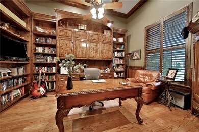 Office features custom built-in shelving.