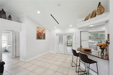 Kitchen featuring lofted ceiling, ornamental moldi