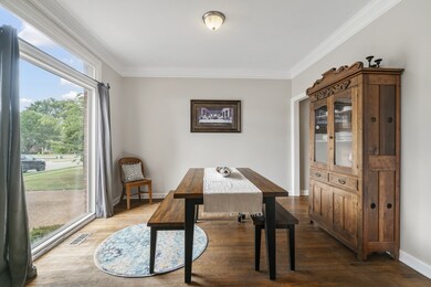 The formal dining room features tons of light through the picture window along with tall ceilings and crown molding.