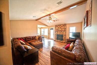 Gleaming wood floors and cozy stone fireplace