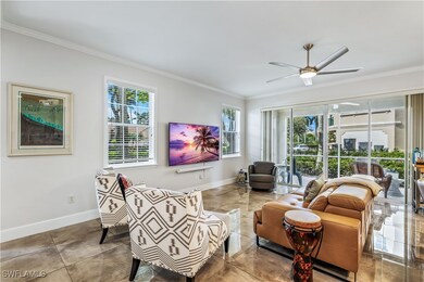 Living room with ceiling fan and crown molding