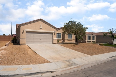 Ranch-style house featuring a garage, concrete dri