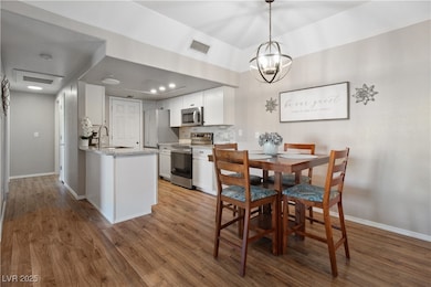 Alternate angle of the Dining Area, in proximity to the Kitchen. Also pictured is the Kitchen breakfast bar, perfect for stool seating for casual dining.