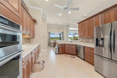 Kitchen with ornamental molding, light tile patter