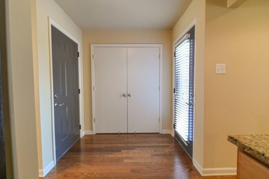 Rich hardwoods and large closet with shelving in t