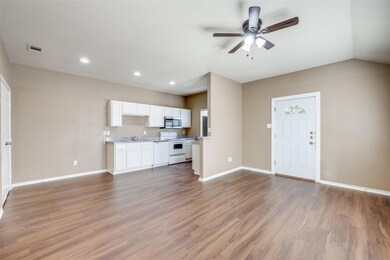 Unfurnished living room featuring vaulted ceiling,