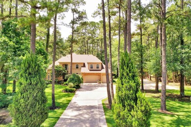 Beautiful home with 3 car oversized garage sits on 1.45 +/- park like acres.