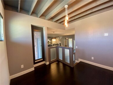 Study with wood floors, detailed ceiling design.