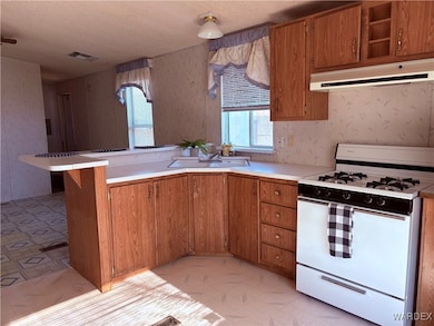 Kitchen featuring kitchen peninsula, a kitchen bar