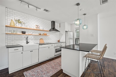 Kitchen with open shelves, tasteful backsplash, w