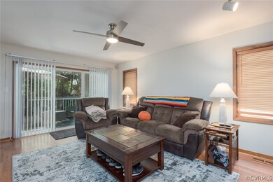 This cozy living room offers sleek lighted ceiling fan and easy access to sliding glass door to rear​​‌​​​​‌​​‌‌​​​‌​​‌‌​​‌‌​‌​​​‌‌​​‌​​​​​‌ deck.