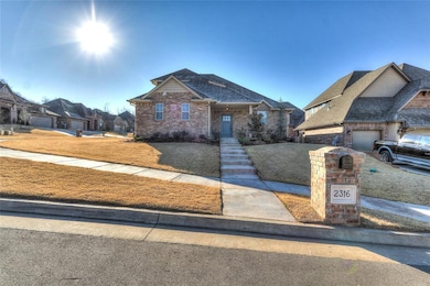 View of front of house with a front yard, roof wit