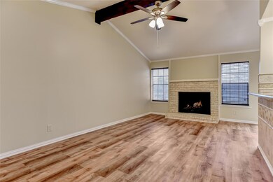 Unfurnished living room featuring a fireplace, bas