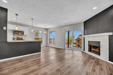Unfurnished living room featuring a tile fireplace