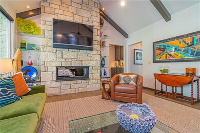 Family room with Austin stone fireplace flanked wi