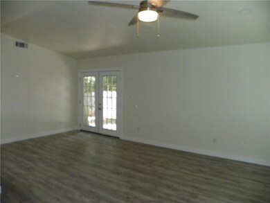 Spare room featuring french doors, wood finished 