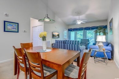 Dining area with baseboards, light colored carpet, a ceiling fan, and high vaulted ceiling