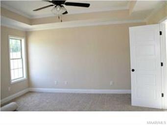 Very large master bedroom with boxed ceiling.