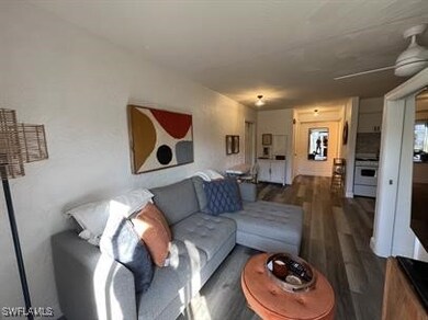Living room with dark hardwood / wood-style floori