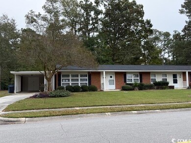 Ranch-style house featuring a carport and a front 