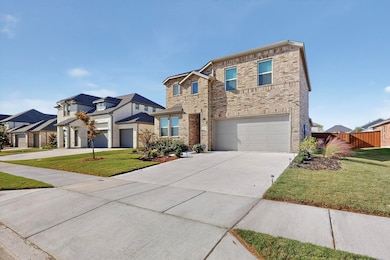 Traditional-style house with driveway, brick siding, an attached garage, and a residential view
