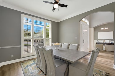 Dining space with ornamental molding, ceiling fan
