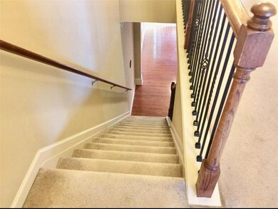 Stairs featuring carpet flooring and wood finished floors