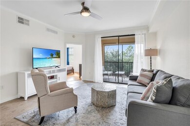 Living room featuring ceiling fan, ornamental mold