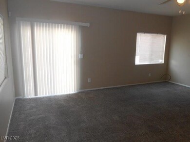 Carpeted spare room with baseboards and ceiling fan