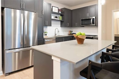 Kitchen featuring sink, a center island, light har