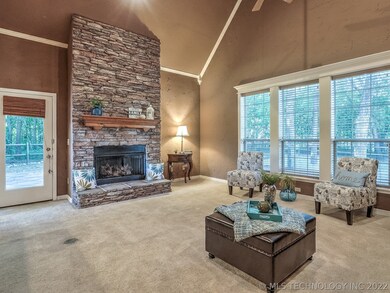 Great room with high ceiling, stacked stone firepl