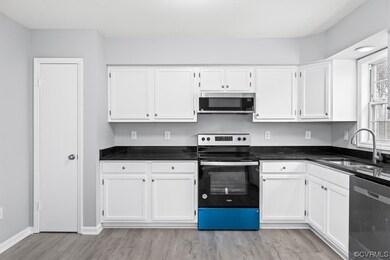 Kitchen featuring sink, light LVP flooring, stainl