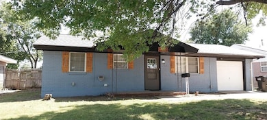 Ranch-style house featuring a garage and brick sid
