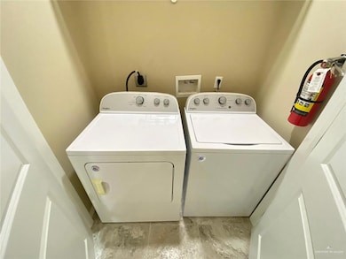 Laundry area featuring laundry area and washer and clothes dryer
