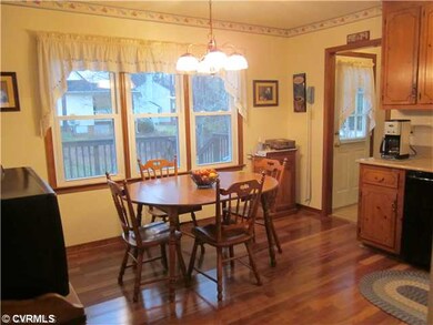 Kitchen - View of Triple Windows and Door leading 