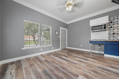 This room features modern gray walls, wood-look fl