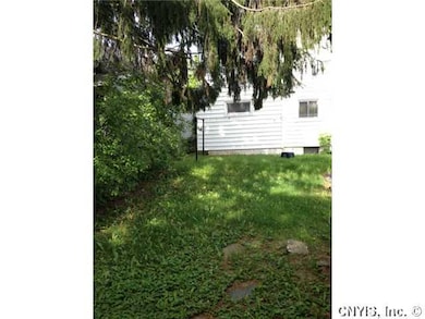 Exterior Back. Deep back yard, adorned with rose b