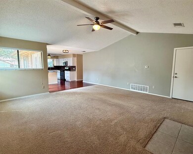Unfurnished living room with ceiling fan, dark ca
