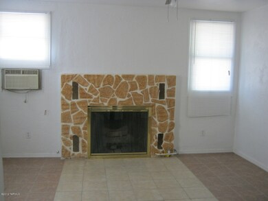 Bedroom with fireplace and wall AC