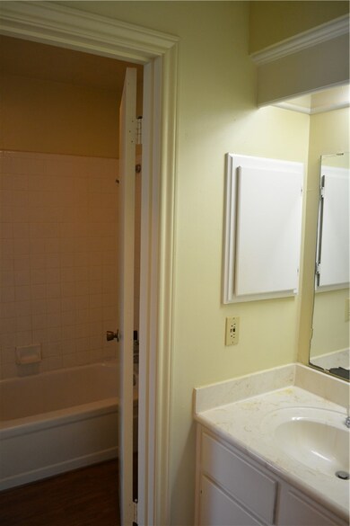 Bathroom with washtub / shower combination, wood f