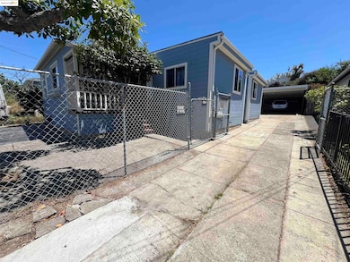View of home's exterior with concrete driveway and an attached carport