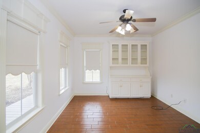 Unfurnished room featuring ceiling fan, dark hardwood / wood-style floors, and crown molding