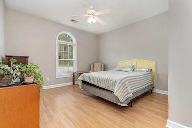 Bedroom with hardwood / wood-style floors, multipl