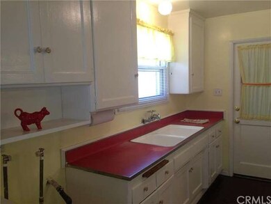 Large work counter with lots of cabinets, a window