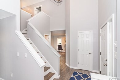 Foyer with new floor, new paint, new hanging light, open