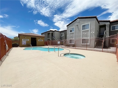 Community pool with a patio and a community hot tu