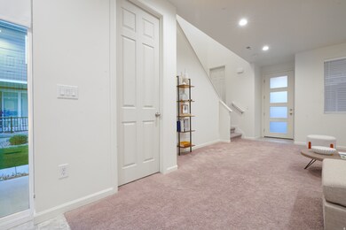 Living area featuring stairway, recessed lighting, and light colored carpet